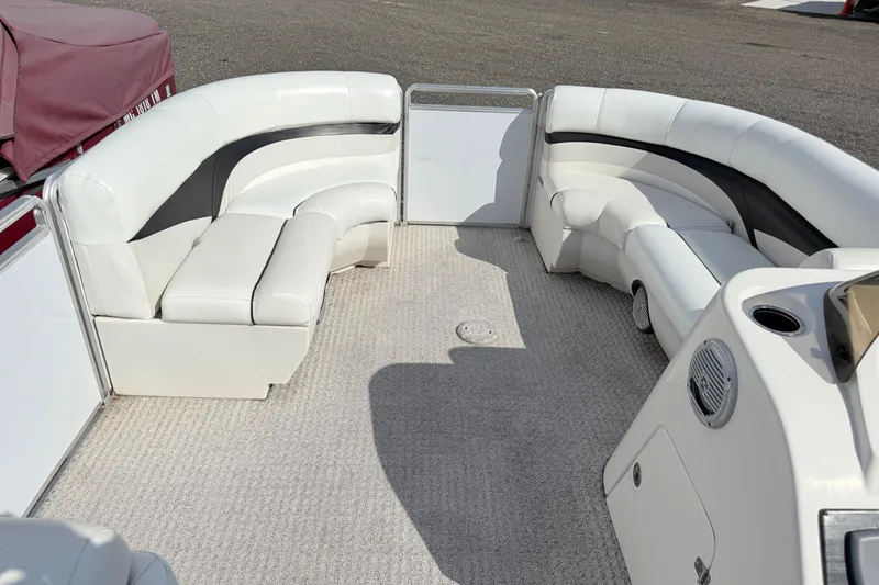 Slide: The Image of 2014 Harris FloteBote 20 pontoon boat interior with white seating and carpeted floor. - 16