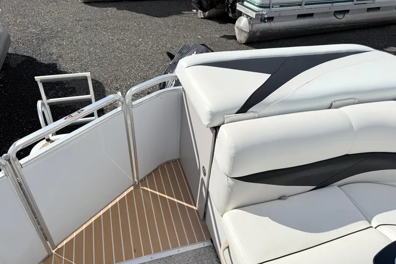 Slide: The Image of 2014 Harris FloteBote 20 pontoon boat with white seating and metal railings. - 17