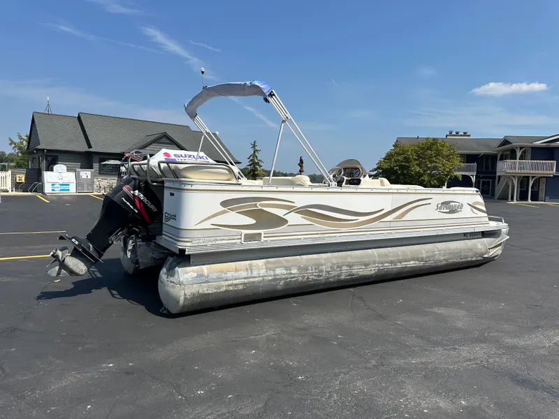 Slide: The Image of 2002 Crest Savannah pontoon boat parked on asphalt under clear blue sky. - 1