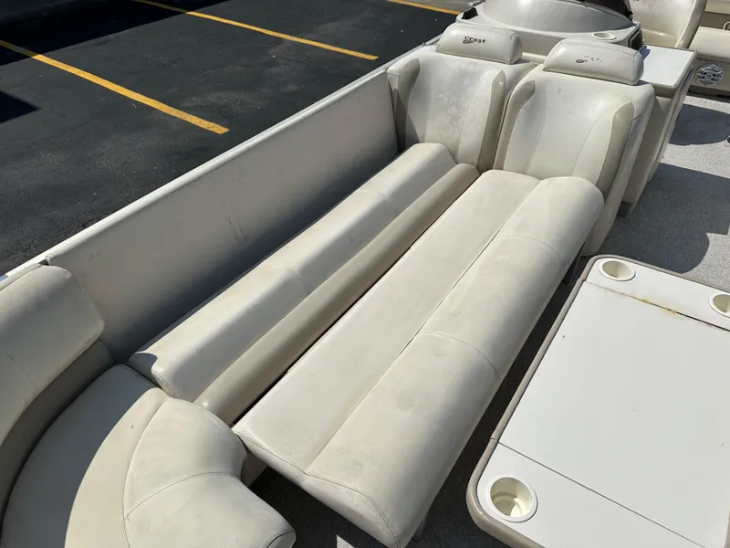 Slide: The Image of 2002 Crest Savannah boat interior with beige seating and cup holders. - 10
