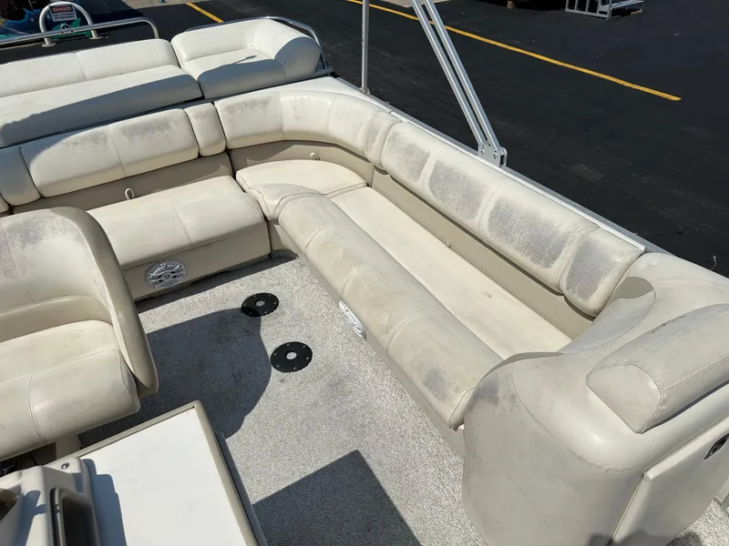 Slide: The Image of 2002 Crest Savannah boat interior with white cushioned seating and carpeted floor. - 14