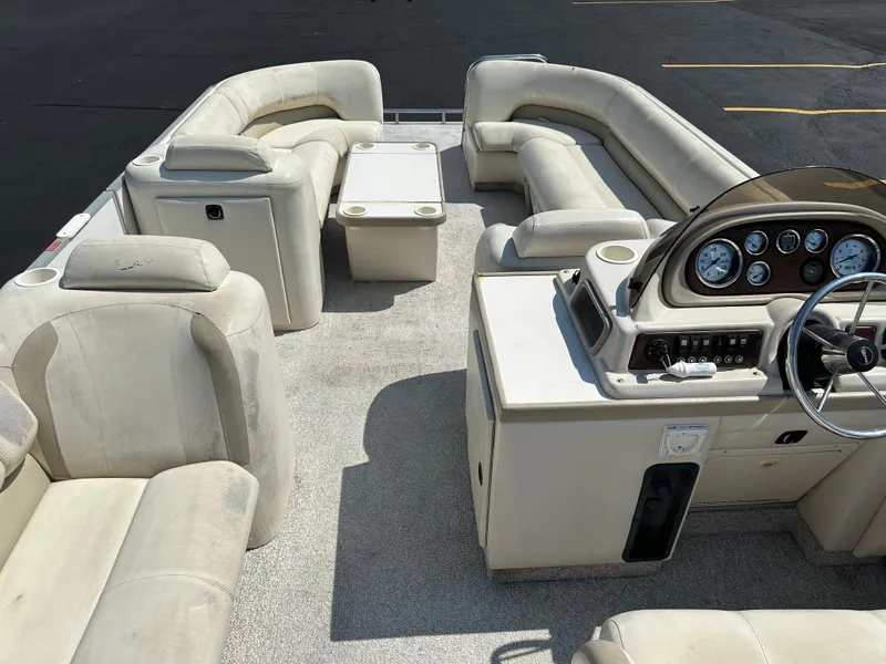 Slide: The Image of 2002 Crest Savannah boat interior with beige seating and control panel. - 16