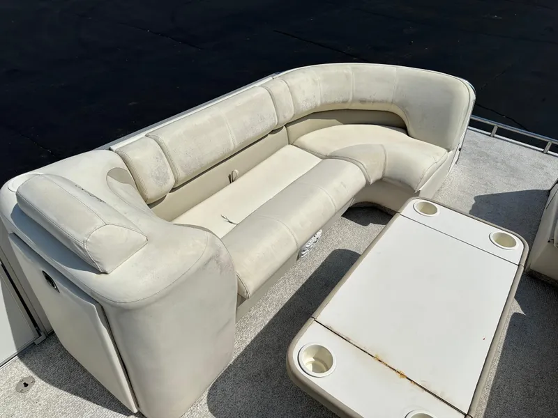 Slide: The Image of 2002 Crest Savannah boat interior with white seating and table. - 5
