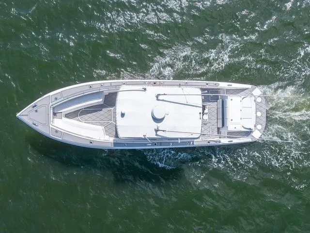 Slide: The Image of Aerial view of 2007 Spectre 37 Center Console boat cruising on water. - 10