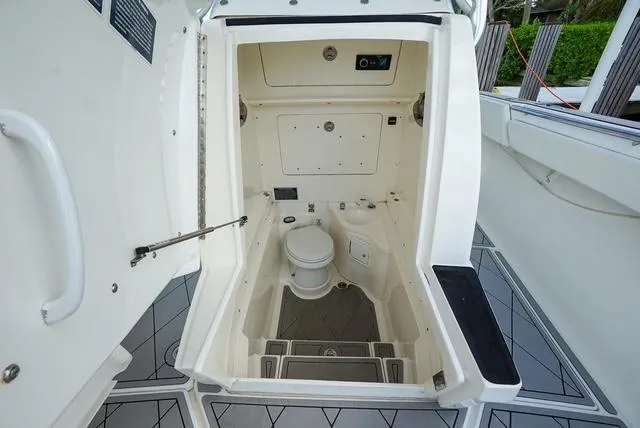 Slide: The Image of 2007 Spectre 37 Center Console boat interior with compact marine toilet. - 14