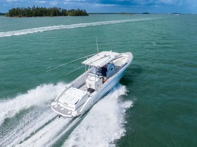 Slide: The Image of 2007 Spectre 37 Center Console boat cruising on open water. - 2