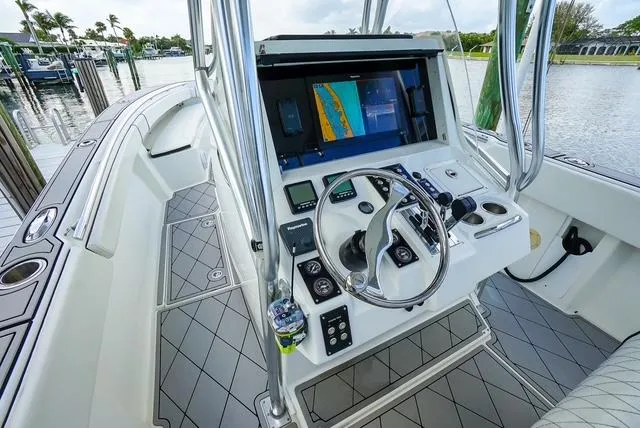 Slide: The Image of 2007 Spectre 37 Center Console boat interior with navigation controls and steering wheel. - 22