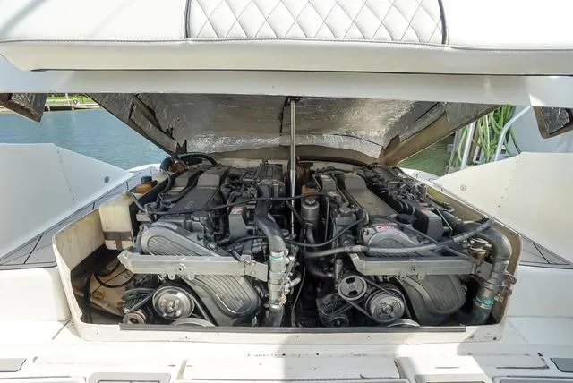 Slide: The Image of 2007 Spectre 37 Center Console boat engine compartment with dual engines. - 25