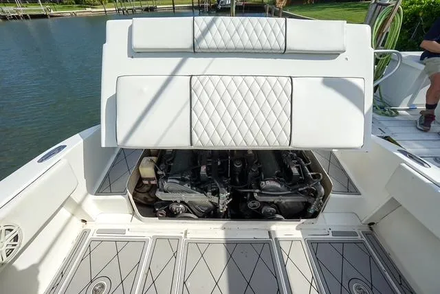 Slide: The Image of 2007 Spectre 37 Center Console boat engine compartment with open hatch, revealing dual engines. - 26