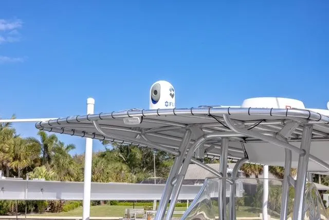 Slide: The Image of 2007 Spectre 37 Center Console boat with FLIR camera on top, clear blue sky background. - 36