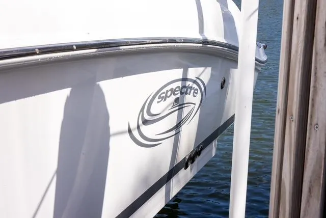 Slide: The Image of 2007 Spectre 37 Center Console boat docked by water. - 37