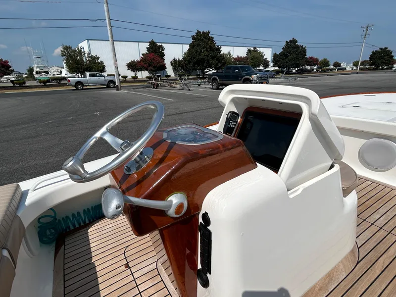 Slide: The Image of 2002 Bayshore Carolina Flats 20 boat dashboard with steering wheel and controls. - 15