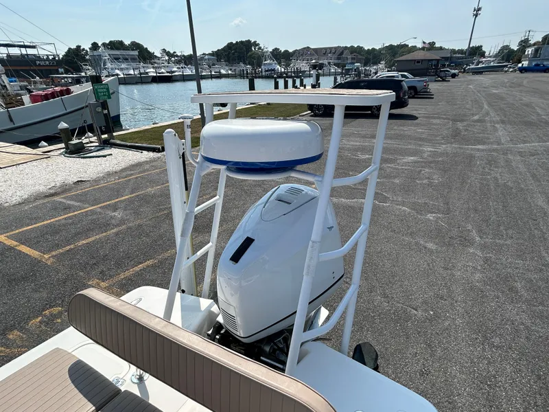 Slide: The Image of Bayshore Carolina Flats 20 boat, 2002 model, docked near marina with outboard motor. - 16