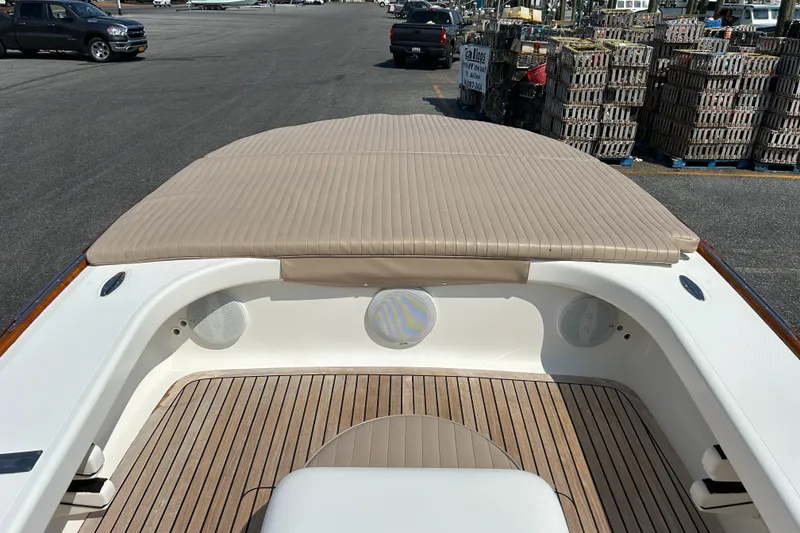 Slide: The Image of 2002 Bayshore Carolina Flats 20 boat interior with beige seating and wood flooring. - 17