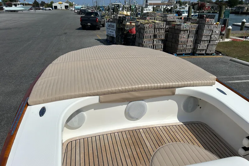 Slide: The Image of 2002 Bayshore Carolina Flats 20 boat with cushioned seating and wooden deck. - 18