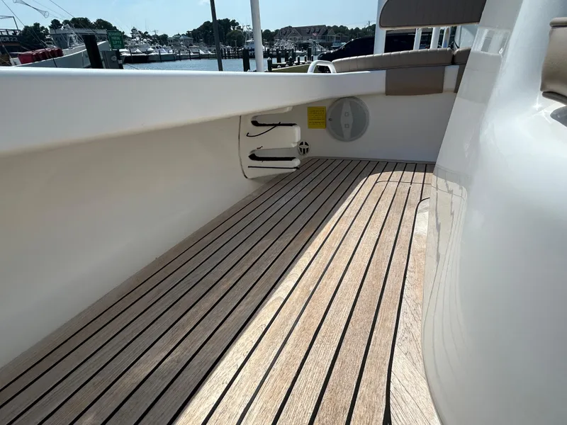 Slide: The Image of 2002 Bayshore Carolina Flats 20 boat with wooden deck, docked at marina. - 19