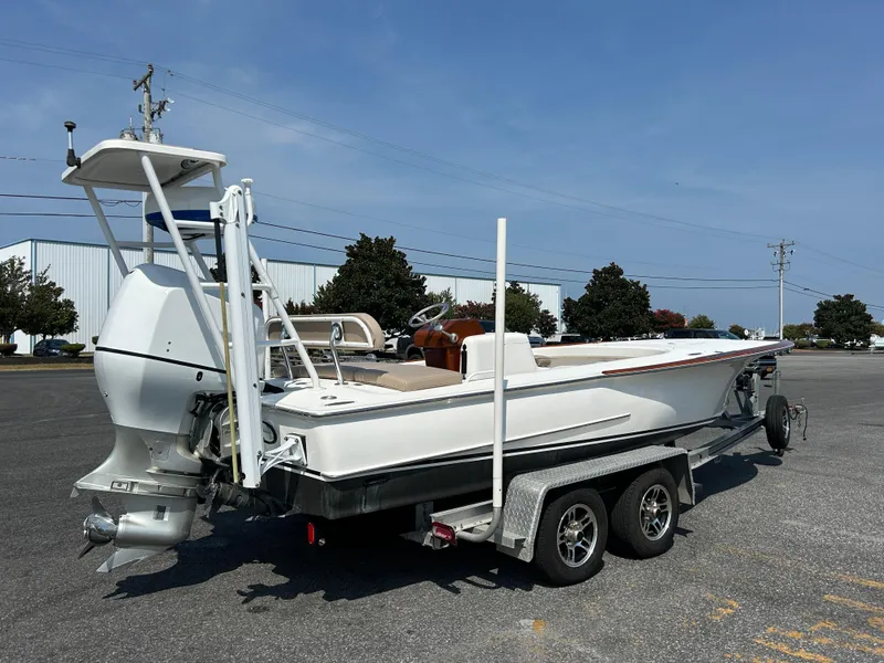 Slide: The Image of 2002 Bayshore Carolina Flats 20 boat on trailer in parking lot. - 2