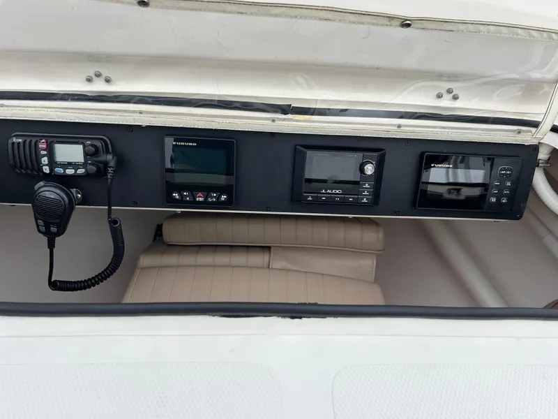 Slide: The Image of 2002 Bayshore Carolina Flats 20 boat dashboard with navigation equipment and radio. - 22