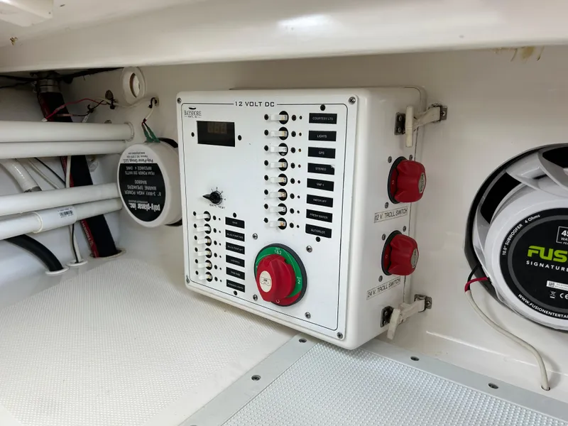 Slide: The Image of Electrical panel in a 2002 Bayshore Carolina Flats 20 boat, featuring switches and a speaker. - 23