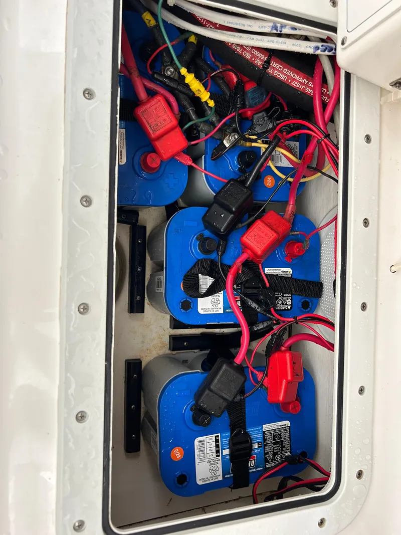Slide: The Image of Boat battery compartment with multiple blue batteries and red cables, Bayshore Carolina Flats 20, 2002. - 25