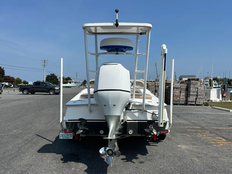 Slide: The Image of 2002 Bayshore Carolina Flats 20 boat with outboard motor in parking lot. - 3