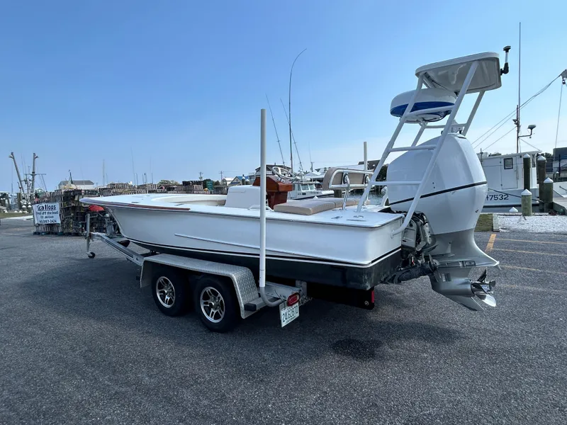 Slide: The Image of 2002 Bayshore Carolina Flats 20 boat on trailer in marina parking lot. - 5