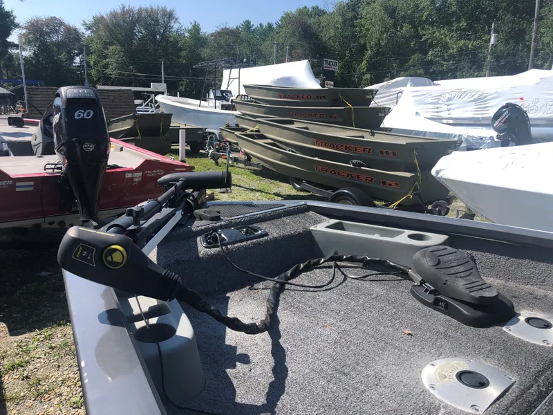 Slide: The Image of 2014 Tracker Pro Team 175 TF boat with motor, parked outdoors. - 11