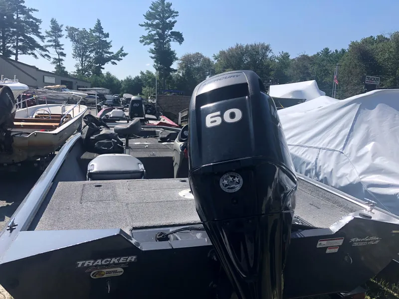 Slide: The Image of 2014 Tracker Pro Team 175 TF boat with 60 HP motor, parked outdoors. - 4