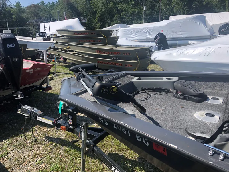 Slide: The Image of 2014 Tracker Pro Team 175 TF boat on trailer, surrounded by other boats. - 7