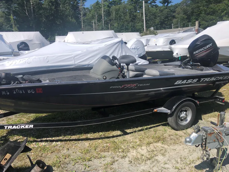 Slide: The Image of 2014 Tracker Pro Team 175 TF bass boat on trailer, parked outdoors. - 8