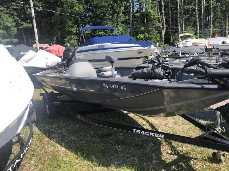 Slide: The Image of 2014 Tracker Pro Team 175 TF boat on trailer, surrounded by other boats. - 9