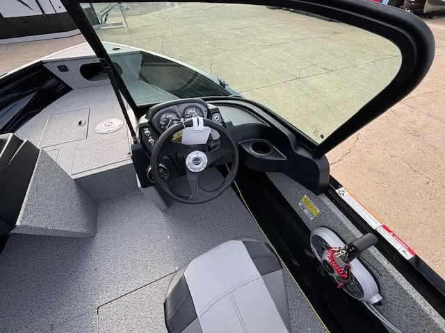 Slide: The Image of 2025 Crestliner 1650 Kodiak boat interior with steering wheel and seating. - 11