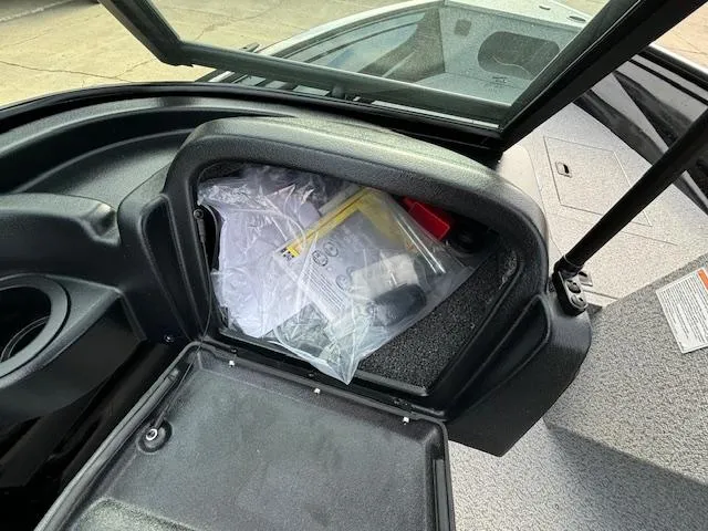 Slide: The Image of Open storage compartment in 2025 Crestliner 1650 Kodiak boat, showing interior contents. - 15