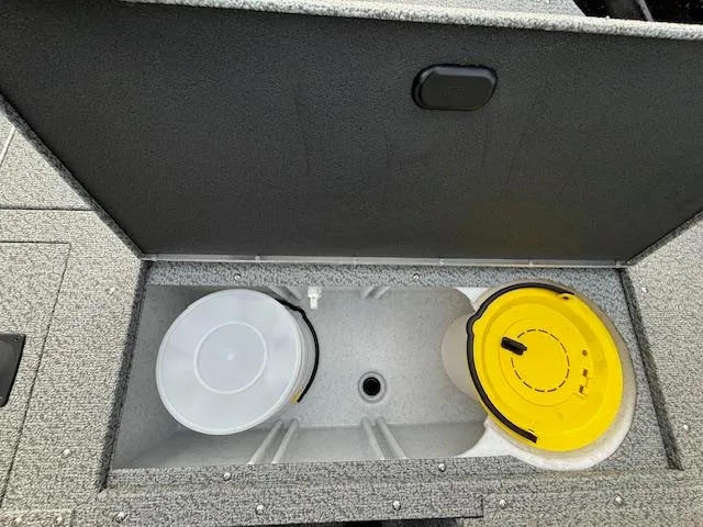 Slide: The Image of 2025 Crestliner 1650 Kodiak storage compartment with yellow and white lids. - 17