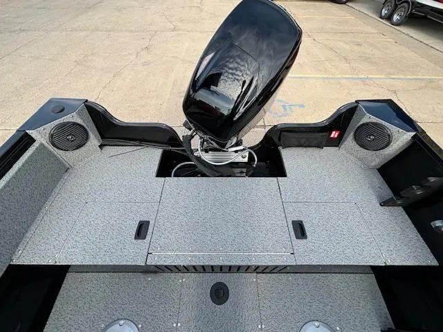 Slide: The Image of 2025 Crestliner 1650 Kodiak boat interior with motor, spacious deck, and storage compartments. - 23