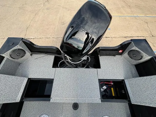 Slide: The Image of 2025 Crestliner 1650 Kodiak boat interior with motor and storage compartments. - 24