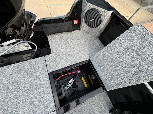 Slide: The Image of 2025 Crestliner 1650 Kodiak boat interior with storage compartment and speaker. - 25