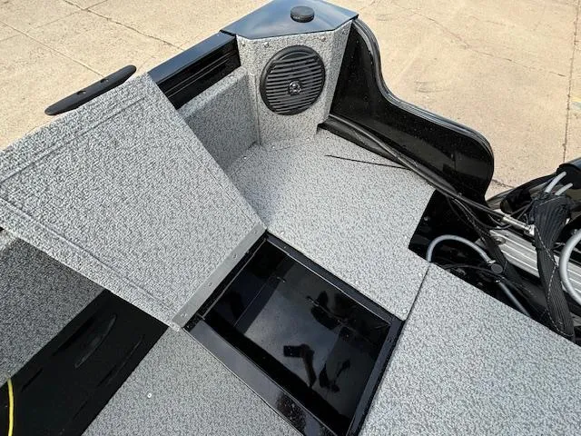 Slide: The Image of 2025 Crestliner 1650 Kodiak boat interior with storage compartment and speaker. - 26