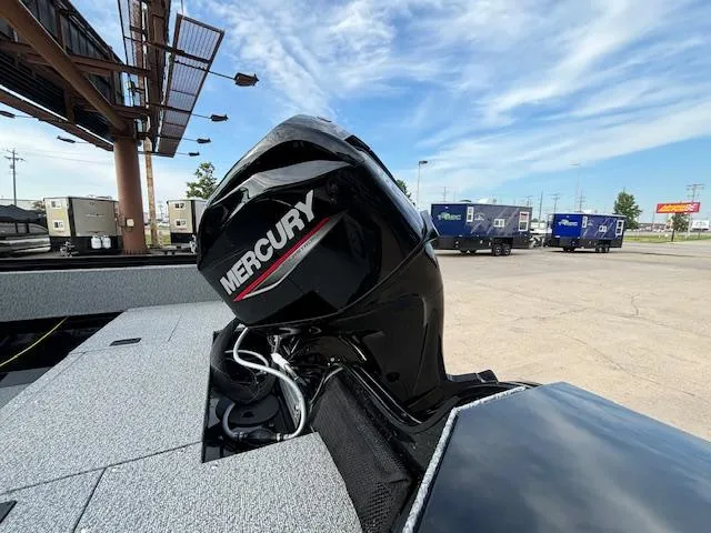 Slide: The Image of 2025 Crestliner 1650 Kodiak boat with Mercury outboard motor in a parking lot. - 3