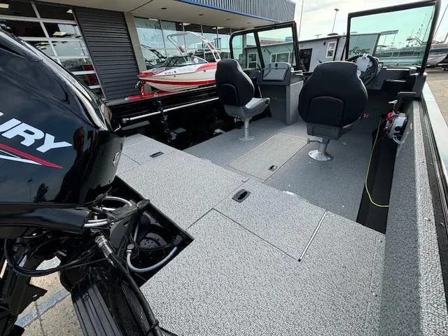 Slide: The Image of 2025 Crestliner 1650 Kodiak boat interior with seating and Mercury outboard motor. - 6