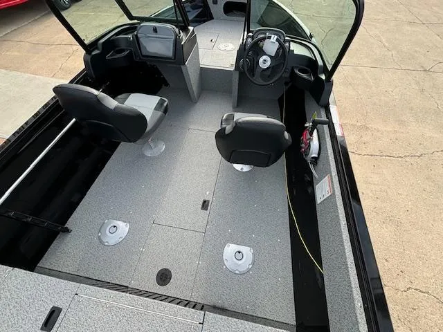 Slide: The Image of 2025 Crestliner 1650 Kodiak boat interior with seating and steering console. - 7