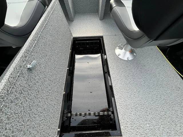 Slide: The Image of 2025 Crestliner 1650 Kodiak boat interior with open storage compartment and seating. - 9