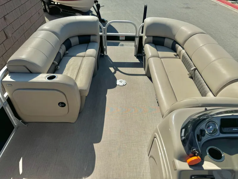 Slide: The Image of 2023 Sun Tracker Sport Fish 22 DLX pontoon boat interior with beige seating. - 13