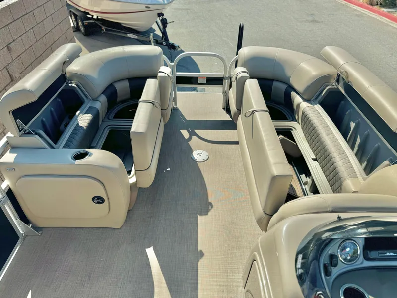 Slide: The Image of 2023 Sun Tracker Sport Fish 22 DLX pontoon boat interior with beige seating. - 14
