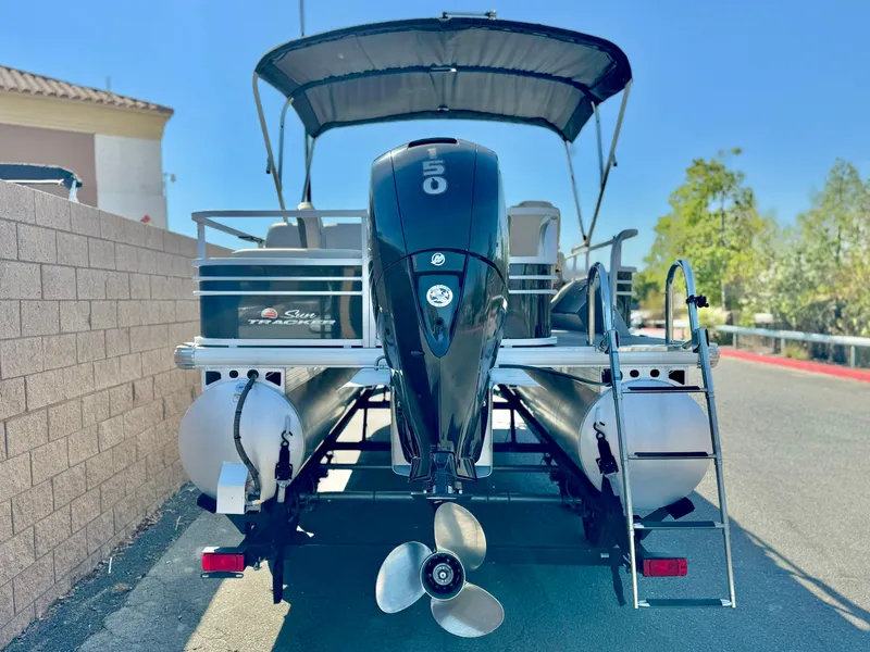 Slide: The Image of 2023 Sun Tracker Sport Fish 22 DLX pontoon boat with outboard motor and canopy. - 5
