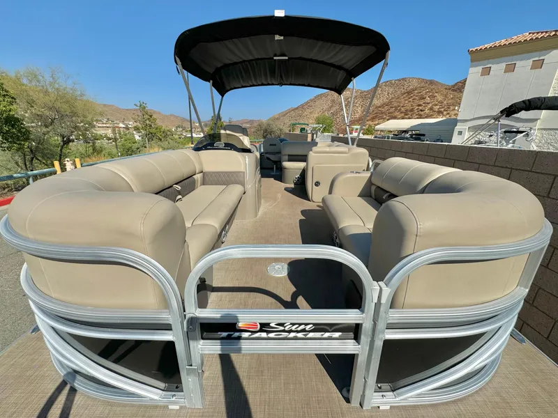 Slide: The Image of 2023 Sun Tracker Sport Fish 22 DLX pontoon boat with beige seating and canopy. - 9