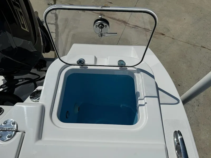 Slide: The Image of Livewell on 2025 NauticStar 242L Offshore boat, open lid, blue interior. - 14
