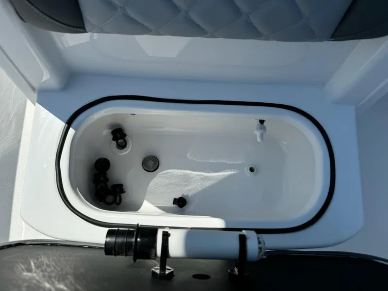Slide: The Image of Livewell in 2025 NauticStar 242L Offshore boat, featuring a clean, white interior. - 16