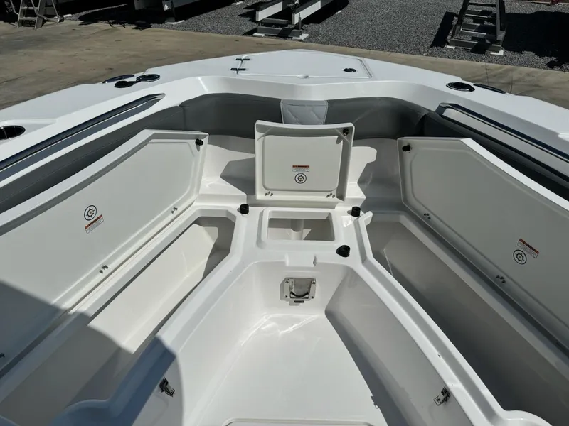 Slide: The Image of 2025 NauticStar 242L Offshore boat interior with open storage compartments. - 21