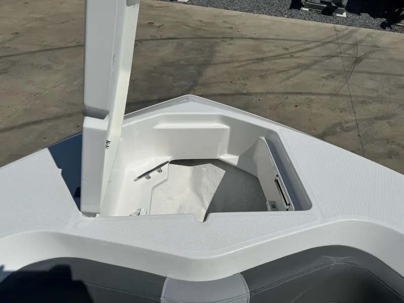 Slide: The Image of 2025 NauticStar 242L Offshore boat with open storage compartment on deck. - 23